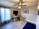 Home office setup featuring wood floors, a ceiling fan, and a bright window at 4854 Flamlau Ave, North Port, FL 34287