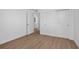 Bedroom featuring wood floors, closet, and a door leading to the bathroom at 49 Troutdale St, Port Charlotte, FL 33954