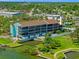 Aerial view of condo featuring waterfront access, a pool, and lush landscaping, creating an idyllic oasis at 53 W Bay Heights Rd # 307, Englewood, FL 34223