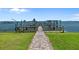 Private boat dock with a pathway leading to the waterfront, perfect for boating enthusiasts and waterfront living at 53 W Bay Heights Rd # 307, Englewood, FL 34223