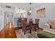 Cozy dining area with glass table and seating, complemented by a view into the modern kitchen at 53 W Bay Heights Rd # 307, Englewood, FL 34223