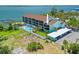 An exterior view of the turquoise condo building showing pool, boat docks, and covered parking at 53 W Bay Heights Rd # 307, Englewood, FL 34223