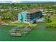 Waterfront condo building featuring private docks and a community swimming pool for residents at 53 W Bay Heights Rd # 307, Englewood, FL 34223