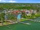 Beautiful waterfront building with docks and lush tropical landscaping surrounding the property at 53 W Bay Heights Rd # 307, Englewood, FL 34223