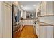 Modern kitchen featuring stainless steel appliances, granite countertops, and ample cabinet space at 53 W Bay Heights Rd # 307, Englewood, FL 34223