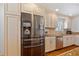 White kitchen with stainless steel refrigerator and dishwasher, and granite countertops at 53 W Bay Heights Rd # 307, Englewood, FL 34223