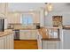 Well-lit kitchen with white cabinets, granite countertops, stainless steel appliances, and breakfast bar at 53 W Bay Heights Rd # 307, Englewood, FL 34223