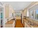 An open kitchen with modern appliances, granite counters and backsplash, and wooden flooring at 53 W Bay Heights Rd # 307, Englewood, FL 34223