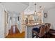 Hallway view of a well-lit kitchen with granite countertops, stainless steel appliances, and breakfast bar seating at 53 W Bay Heights Rd # 307, Englewood, FL 34223