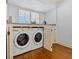 This laundry room offers convenience with a washer and dryer, making laundry tasks easier and more efficient at 53 W Bay Heights Rd # 307, Englewood, FL 34223