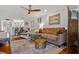 Bright living space showcasing a comfortable seating arrangement, wood floors, and seamless flow to the kitchen at 53 W Bay Heights Rd # 307, Englewood, FL 34223