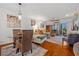 Open-concept living area with hardwood floors, stylish furnishings, and balcony access for indoor-outdoor living at 53 W Bay Heights Rd # 307, Englewood, FL 34223