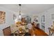 Bright living room featuring hardwood floors, comfortable seating, and access to an outdoor balcony at 53 W Bay Heights Rd # 307, Englewood, FL 34223