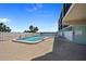 View of the community pool area, surrounded by a privacy fence and palm trees at 53 W Bay Heights Rd # 307, Englewood, FL 34223
