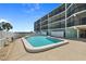 A beautiful waterfront community pool, surrounded by palm trees and tropical landscaping at 53 W Bay Heights Rd # 307, Englewood, FL 34223