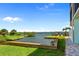 Stunning waterfront view with a pelican statue, dock, and lush greenery offering serene coastal living at 53 W Bay Heights Rd # 307, Englewood, FL 34223