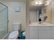 Modern bathroom boasts a large mirror and vanity, toilet, and walk-in shower at 5725 Greenwood Ave # 5103, North Port, FL 34287