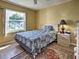 Bedroom with a comfortable bed, bedside table, and natural light from the window at 5725 Greenwood Ave # 5103, North Port, FL 34287