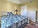 Bedroom with comfortable bed, dresser, and double door closet, perfect for relaxation at 5725 Greenwood Ave # 5103, North Port, FL 34287