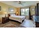Inviting bedroom with large window, ceiling fan, wood flooring, and two side tables with lamps at 5725 Greenwood Ave # 5103, North Port, FL 34287
