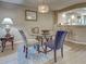 Dining area includes a glass table and bar seating that opens up into the kitchen at 5725 Greenwood Ave # 5103, North Port, FL 34287