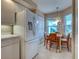 Well-equipped kitchen with modern white appliances, pantry, and cozy dining area with natural light at 5725 Greenwood Ave # 5103, North Port, FL 34287