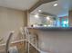 Kitchen includes white cabinets, a modern faucet, and bar seating at 5725 Greenwood Ave # 5103, North Port, FL 34287