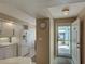 Bright kitchen entrance with access to outside featuring white appliances at 5725 Greenwood Ave # 5103, North Port, FL 34287