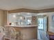 Open kitchen featuring a breakfast bar, white cabinets, and modern appliances at 5725 Greenwood Ave # 5103, North Port, FL 34287