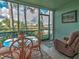 Enclosed lanai boasts beautiful views of the lush surroundings from the seating area at 5725 Greenwood Ave # 5103, North Port, FL 34287