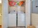 Convenient laundry area with washer, dryer, and overhead storage for efficient chores at 5725 Greenwood Ave # 5103, North Port, FL 34287