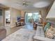 Comfortable living room featuring a large window and access to a patio with outdoor seating at 5725 Greenwood Ave # 5103, North Port, FL 34287