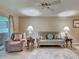 Cozy living room with a ceiling fan, side tables with lamps, a stylish sofa, and neutral colored walls at 5725 Greenwood Ave # 5103, North Port, FL 34287