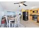 Open-concept dining room adjacent to the kitchen, featuring modern appliances and a ceiling fan at 5983 Hobhill Ave, North Port, FL 34287