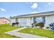 Attractive single-story home with a vibrant green lawn, sidewalk, and inviting front entrance at 5983 Hobhill Ave, North Port, FL 34287