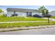 Charming single-story home featuring a well-maintained lawn, front shrubs, and an attached garage at 5983 Hobhill Ave, North Port, FL 34287