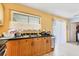 Well-lit kitchen featuring laminate countertops, window, and ample cabinet space at 5983 Hobhill Ave, North Port, FL 34287