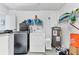 Laundry room featuring a modern washer and dryer at 5983 Hobhill Ave, North Port, FL 34287