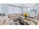 Inviting living room featuring a comfortable couch, large window, and neutral, calming color scheme at 5983 Hobhill Ave, North Port, FL 34287