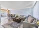Open concept living and dining area with modern sofas, dining set, and large sliding glass door at 5983 Hobhill Ave, North Port, FL 34287