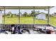 View from the screened porch to the backyard with green grass and storage shed at 5983 Hobhill Ave, North Port, FL 34287