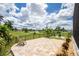 Paver patio overlooks lush backyard, wrought iron fence and serene pond views at 609 Monaco Dr, Punta Gorda, FL 33950