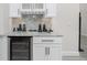 Elegant bar area with wine fridge, stylish countertops, and ample storage space for entertaining at 609 Monaco Dr, Punta Gorda, FL 33950