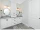 Bathroom featuring double sinks, granite counters, and modern light fixtures at 609 Monaco Dr, Punta Gorda, FL 33950
