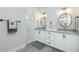 Bathroom featuring double sinks, granite counters, and a marble tiled shower stall at 609 Monaco Dr, Punta Gorda, FL 33950