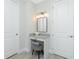 Bathroom vanity area featuring granite counters, a mirror and modern lighting fixtures at 609 Monaco Dr, Punta Gorda, FL 33950