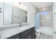 Modern bathroom features a granite vanity, a sink, and a shower/tub combo with tile surround at 609 Monaco Dr, Punta Gorda, FL 33950