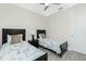 Bright bedroom with twin beds, a ceiling fan, and neutral decor at 609 Monaco Dr, Punta Gorda, FL 33950