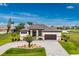 Stunning single-story home boasting a paver driveway, tile roof, and perfectly manicured landscaping at 609 Monaco Dr, Punta Gorda, FL 33950