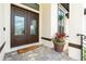 Inviting double front doors, a charming 'Hello' mat, and a beautiful potted plant create a welcoming entrance at 609 Monaco Dr, Punta Gorda, FL 33950